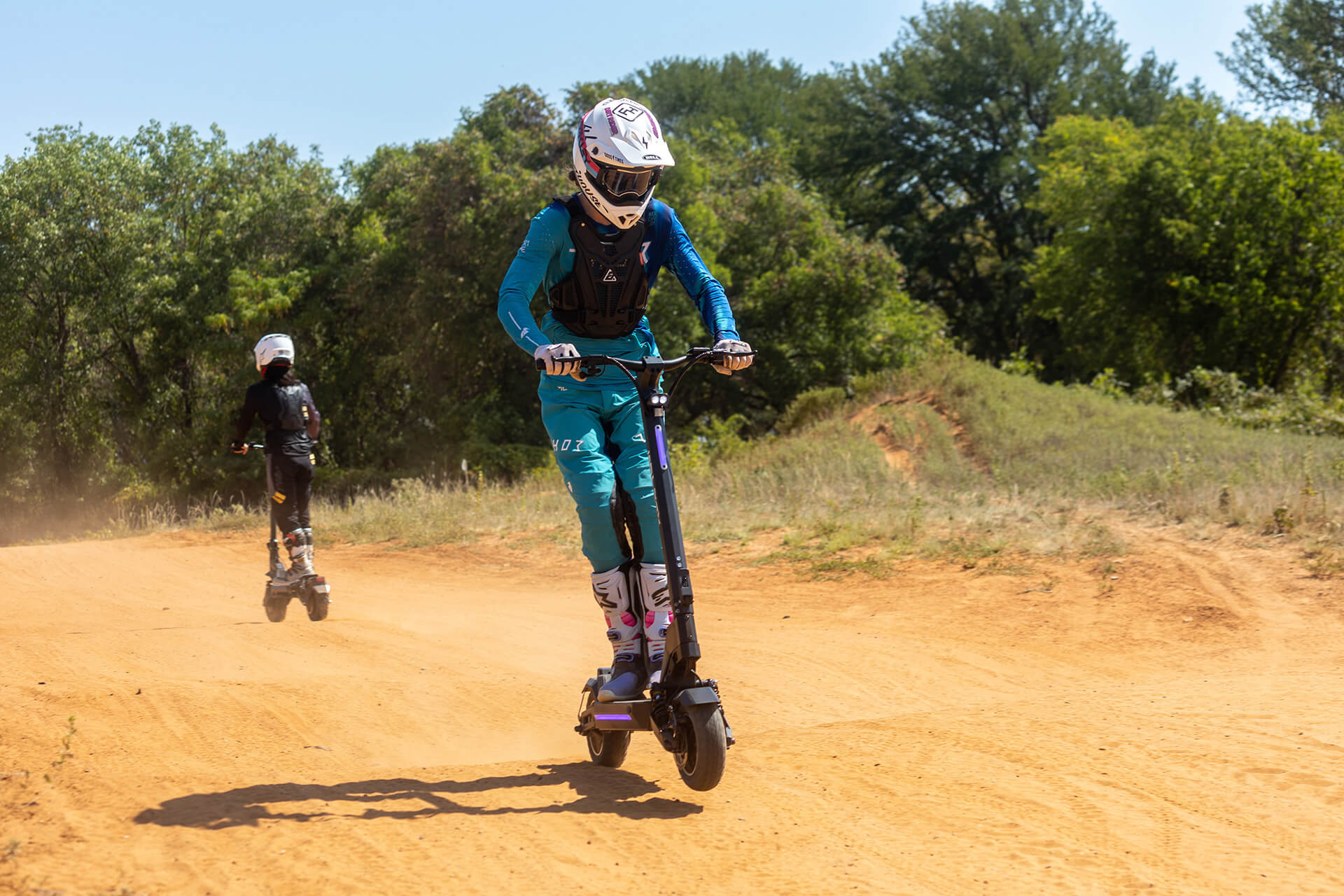 Person riding the GOTRAX GX1 Performance Series Electric Scooter Off Road
